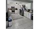 The kitchen has white cabinets, stainless steel appliances, and a gray geometric rug at 119 Caddy Rd, Rotonda West, FL 33947