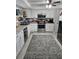 Bright kitchen featuring granite countertops, white cabinets and stainless appliances at 119 Caddy Rd, Rotonda West, FL 33947