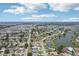 Expansive aerial view of a residential community with a lake and distant ocean view at 1301 Lucaya Ave, Venice, FL 34285