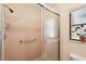 Bathroom featuring a tiled shower with sliding glass doors and safety grab bars at 1301 Lucaya Ave, Venice, FL 34285