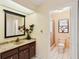 Well-lit bathroom featuring a vanity with sink and walk-in shower at 1301 Lucaya Ave, Venice, FL 34285