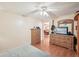 Bedroom featuring laminate wood floors, ceiling fan, and views into the dining room at 1301 Lucaya Ave, Venice, FL 34285