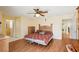 Charming bedroom featuring wood floors, ceiling fan, and ensuite bathroom at 1301 Lucaya Ave, Venice, FL 34285