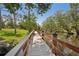 Scenic community walkway with a wooden railing over a calm waterway at 1301 Lucaya Ave, Venice, FL 34285