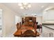 Formal dining room featuring a wood table with seating and chandelier lighting at 1301 Lucaya Ave, Venice, FL 34285