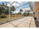 Large enclosed patio with a grassy area outside the screen and an access door to the house at 1301 Lucaya Ave, Venice, FL 34285