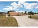 A long concrete driveway leads to a two-car garage, complemented by a well-kept yard at 1301 Lucaya Ave, Venice, FL 34285