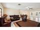 Spacious living room featuring tile and wood floors, a fan, and leather sofas at 1301 Lucaya Ave, Venice, FL 34285