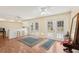 Sunlit living room with bar, two sets of glass doors, and tile flooring at 1301 Lucaya Ave, Venice, FL 34285
