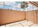 Enclosed patio featuring a textured privacy wall with views of the sky and a single palm tree at 1301 Lucaya Ave, Venice, FL 34285