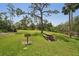 Community picnic area featuring a grill and picnic table under a large tree at 1301 Lucaya Ave, Venice, FL 34285