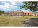 Grassy back yard featuring screened in patio with double doors at 1301 Lucaya Ave, Venice, FL 34285