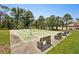 Community shuffleboard courts with benches and lighting, surrounded by trees at 1301 Lucaya Ave, Venice, FL 34285