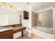 Full bathroom with a shower-tub combination and a large vanity with granite countertop at 14174 Oakham St, Tampa, FL 33626