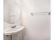 Elegant half bathroom features a pedestal sink and a circular mirror at 14174 Oakham St, Tampa, FL 33626