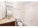 Traditional bathroom with a dark vanity and a white shower-tub combo at 14174 Oakham St, Tampa, FL 33626