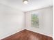 A well lit bedroom featuring wood floors and a large window at 14174 Oakham St, Tampa, FL 33626
