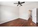 Inviting bedroom with hardwood floors, ceiling fan, and ample natural light at 14174 Oakham St, Tampa, FL 33626