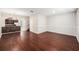 Open-concept living area featuring stylish hardwood floors and seamless flow to the kitchen at 14174 Oakham St, Tampa, FL 33626