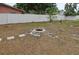Wide open backyard with a stone fire pit and a tall, white vinyl fence surrounding the property at 2824 Oaklawn Ave, Largo, FL 33771
