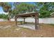 Backyard featuring a wooden pavilion structure on a concrete base and a white vinyl fence at 2824 Oaklawn Ave, Largo, FL 33771