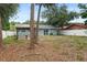Backyard featuring a grey house, pavilion, sliding glass doors, and white vinyl fence at 2824 Oaklawn Ave, Largo, FL 33771