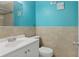 Cozy bathroom featuring a single sink vanity, toilet and tile flooring with seaside decoration at 2824 Oaklawn Ave, Largo, FL 33771