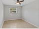 Bedroom with tile floor and ceiling fan, offers a bright space with a window view at 2824 Oaklawn Ave, Largo, FL 33771