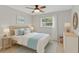 Bright bedroom with a ceiling fan, large window, and light-colored furnishings at 2824 Oaklawn Ave, Largo, FL 33771