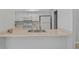 Well-lit kitchen features white cabinets, stainless sink, and neutral countertops at 2824 Oaklawn Ave, Largo, FL 33771