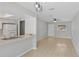 Open-concept living room and kitchen featuring tile flooring, white walls, and contemporary light fixtures at 2824 Oaklawn Ave, Largo, FL 33771
