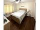 Comfortable bedroom featuring light hardwood floors and a ceiling fan at 3628 Nettle Creek Ct, Holiday, FL 34691