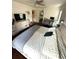 Comfortable bedroom features dark hardwood floors and a large dresser with drawers at 3628 Nettle Creek Ct, Holiday, FL 34691