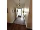 Inviting entryway with tiled floor, decorative chandelier, and open door at 3628 Nettle Creek Ct, Holiday, FL 34691