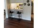Kitchen bar with black barstools that opens to another room at 3628 Nettle Creek Ct, Holiday, FL 34691