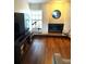 Cozy living room area with a white brick fireplace and wood flooring at 3628 Nettle Creek Ct, Holiday, FL 34691