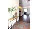 Open layout showcasing a foyer table which leads to a living room featuring a fireplace and sliding glass doors at 3628 Nettle Creek Ct, Holiday, FL 34691