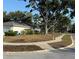 Well-maintained corner lot with mature trees and landscaping features a blue fire hydrant at 3628 Nettle Creek Ct, Holiday, FL 34691