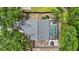 An aerial view shows the house, roof, screened in pool, patio and back yard at 4605 Steel Dust Ln, Lutz, FL 33559