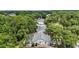 Aerial view of backyard with screened pool surrounded by mature landscaping at 4605 Steel Dust Ln, Lutz, FL 33559