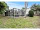 The property offers a screened pool area and ample backyard greenspace at 4605 Steel Dust Ln, Lutz, FL 33559