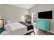 Comfortable bedroom with hardwood floors, natural light, and blue dresser at 4605 Steel Dust Ln, Lutz, FL 33559