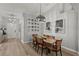 Dining room with modern light fixture, neutral paint color, and hardwood flooring at 4605 Steel Dust Ln, Lutz, FL 33559