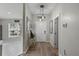 Welcoming entryway with hardwood floors, modern lighting, and an inviting open floor plan at 4605 Steel Dust Ln, Lutz, FL 33559