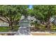 Inviting single Gathering home with a large driveway, mature trees, and a well-manicured lawn at 4605 Steel Dust Ln, Lutz, FL 33559