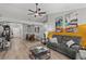Bright living room with a ceiling fan, hardwood floors, comfortable seating and stylish decorations at 4605 Steel Dust Ln, Lutz, FL 33559