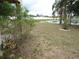 Expansive backyard with lush grass and views of the lake, offering a serene outdoor space at 11511 Misty Isle Ln, Riverview, FL 33579