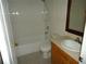 A bathroom with cream vanity and white tub at 11511 Misty Isle Ln, Riverview, FL 33579