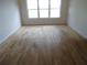 Spacious bedroom with large windows and light hardwood floors, creating an airy feel at 11511 Misty Isle Ln, Riverview, FL 33579