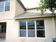 Beige home with windows and view of the side yard and lake behind it at 11511 Misty Isle Ln, Riverview, FL 33579